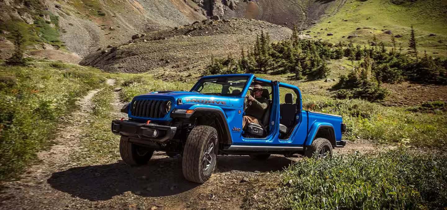 2026 Jeep Gladiator driving up the side of a hill