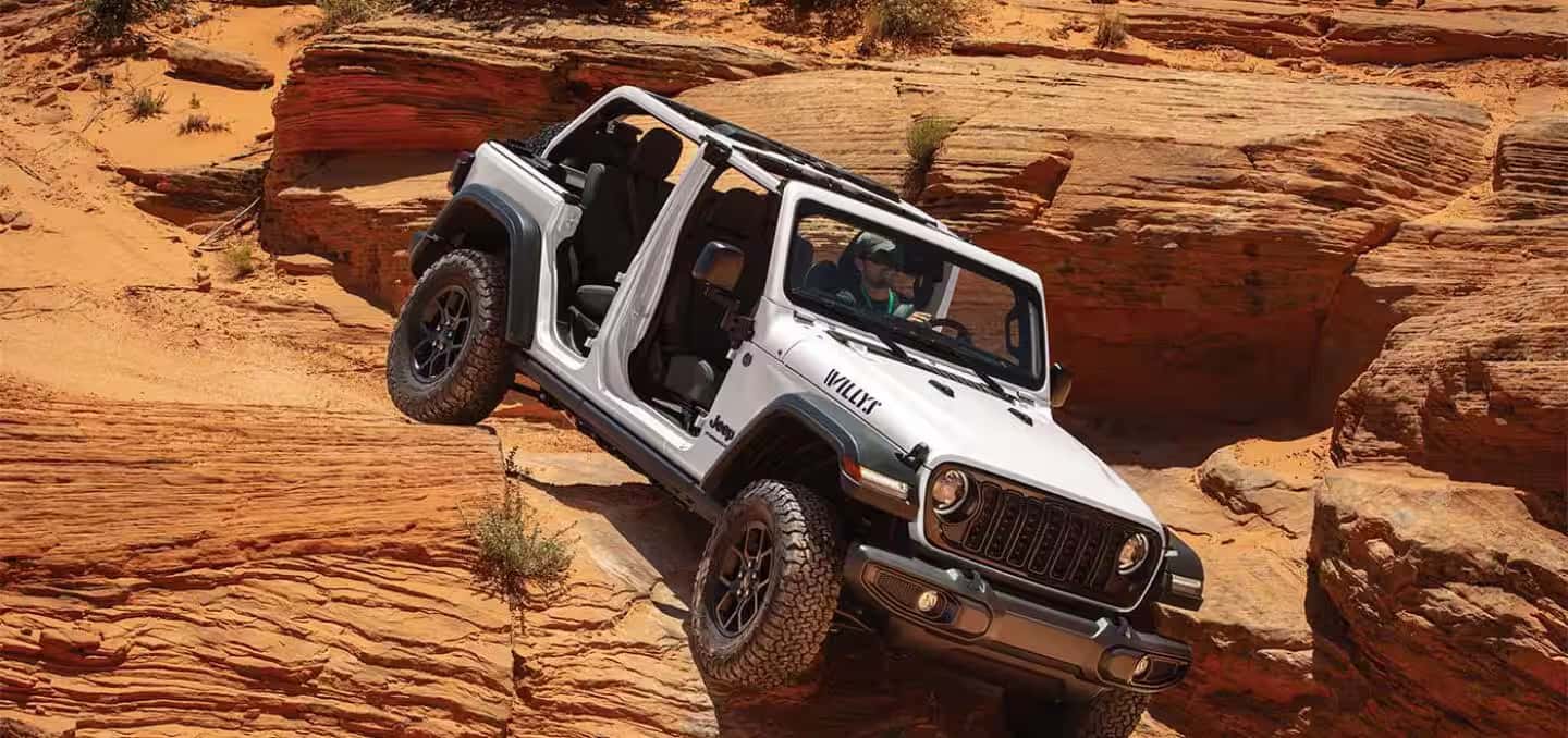 a 2026 Jeep Wrangler Driving down a rock wall