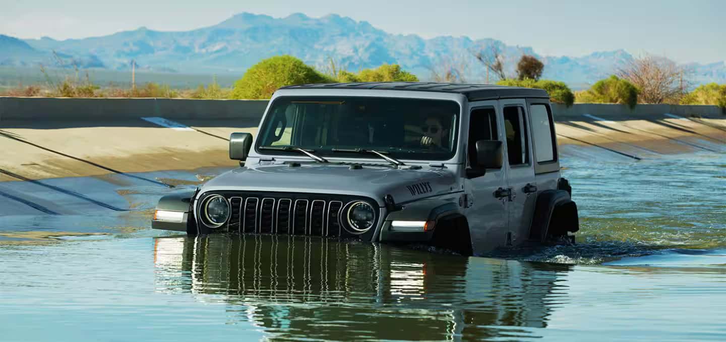 a 2026 Jeep Wrangler driving in water