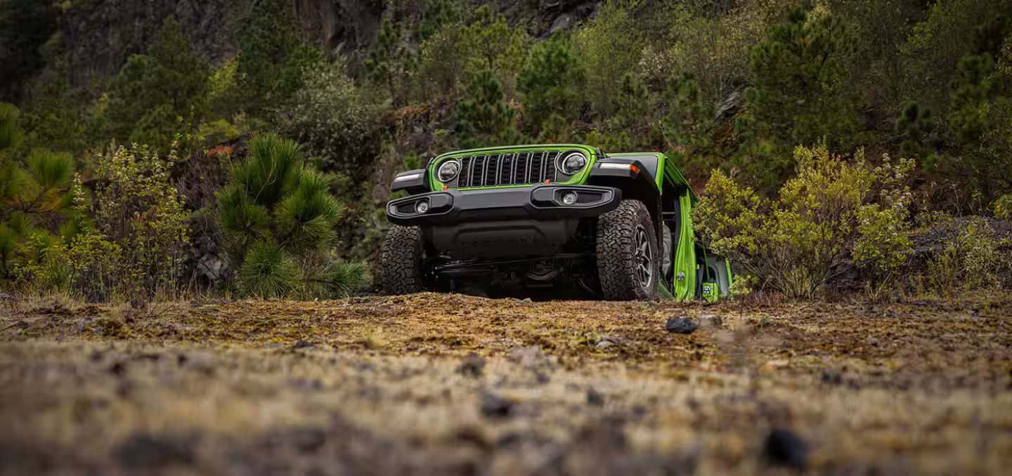 a 2026 Jeep Wrangler driving up a hill