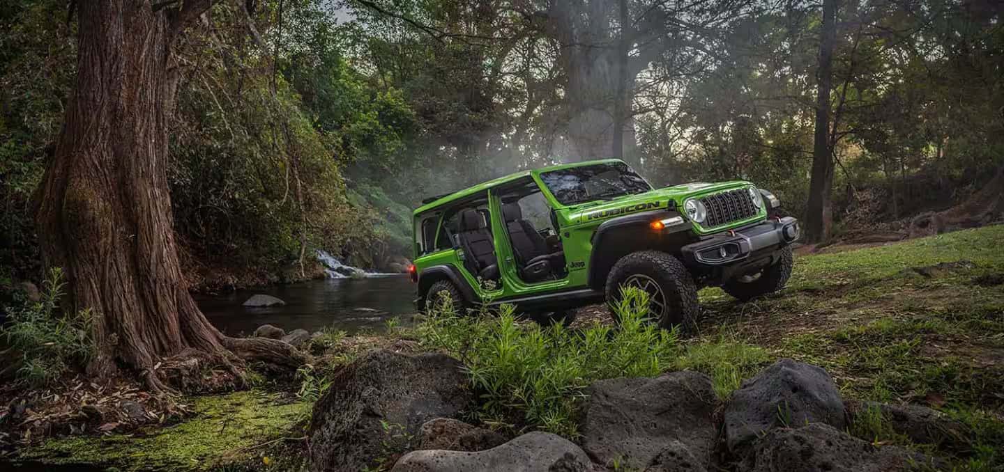 a 2026 Jeep Wrangler driving in a forest