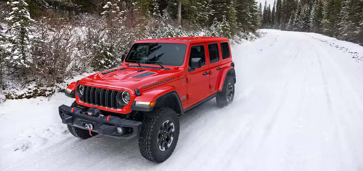a 2026 Jeep Wrangler driving in the snow