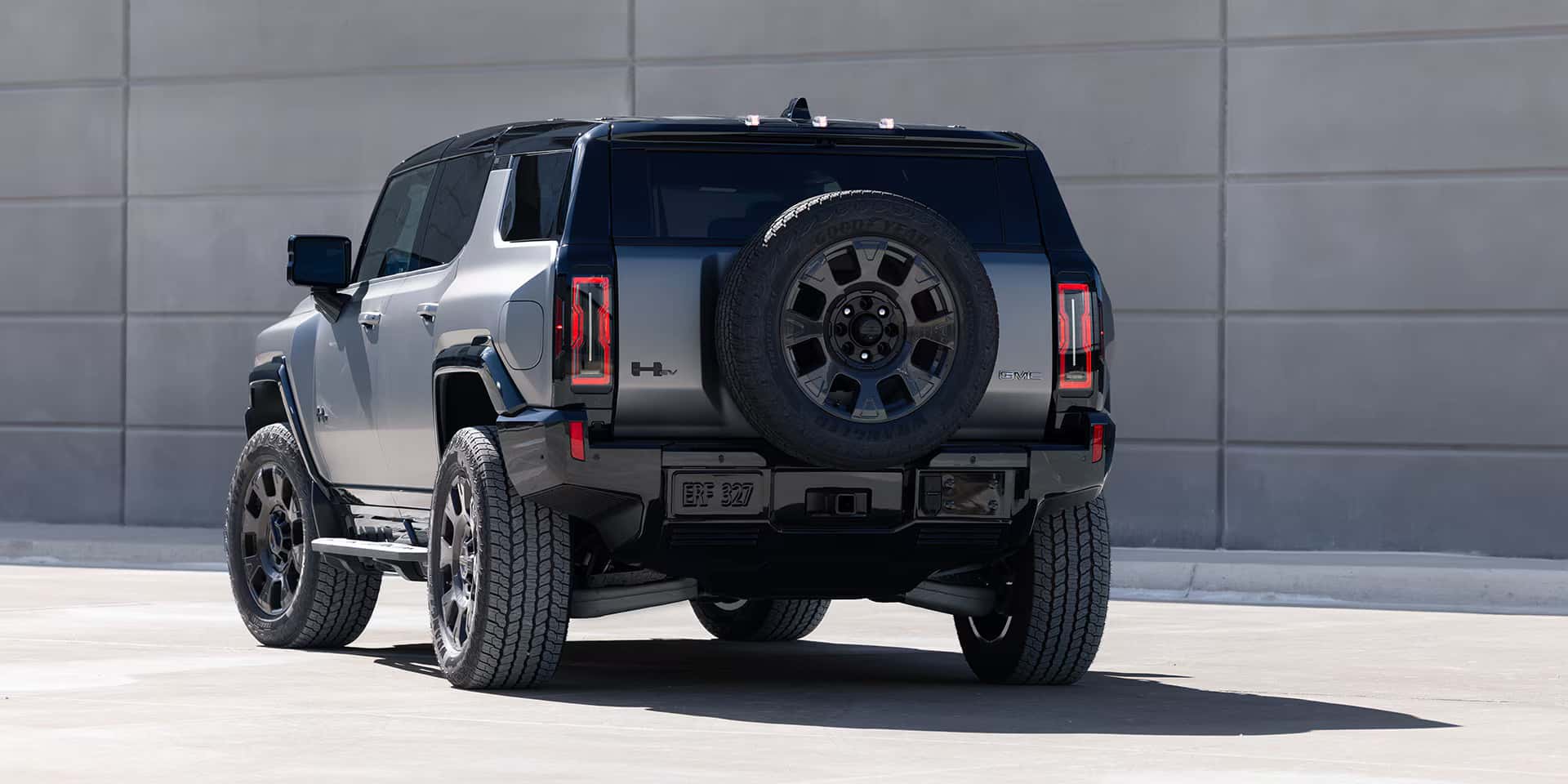 a 2026 Hummer EV SUV parked next to a building