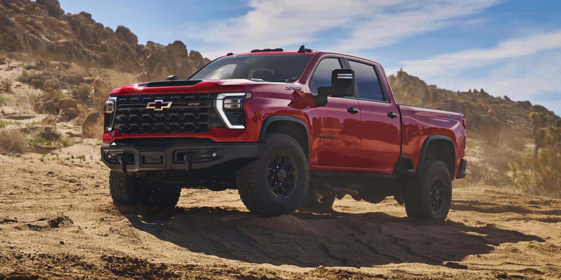 2026 Chevy Silverado HD parked in a sandy path