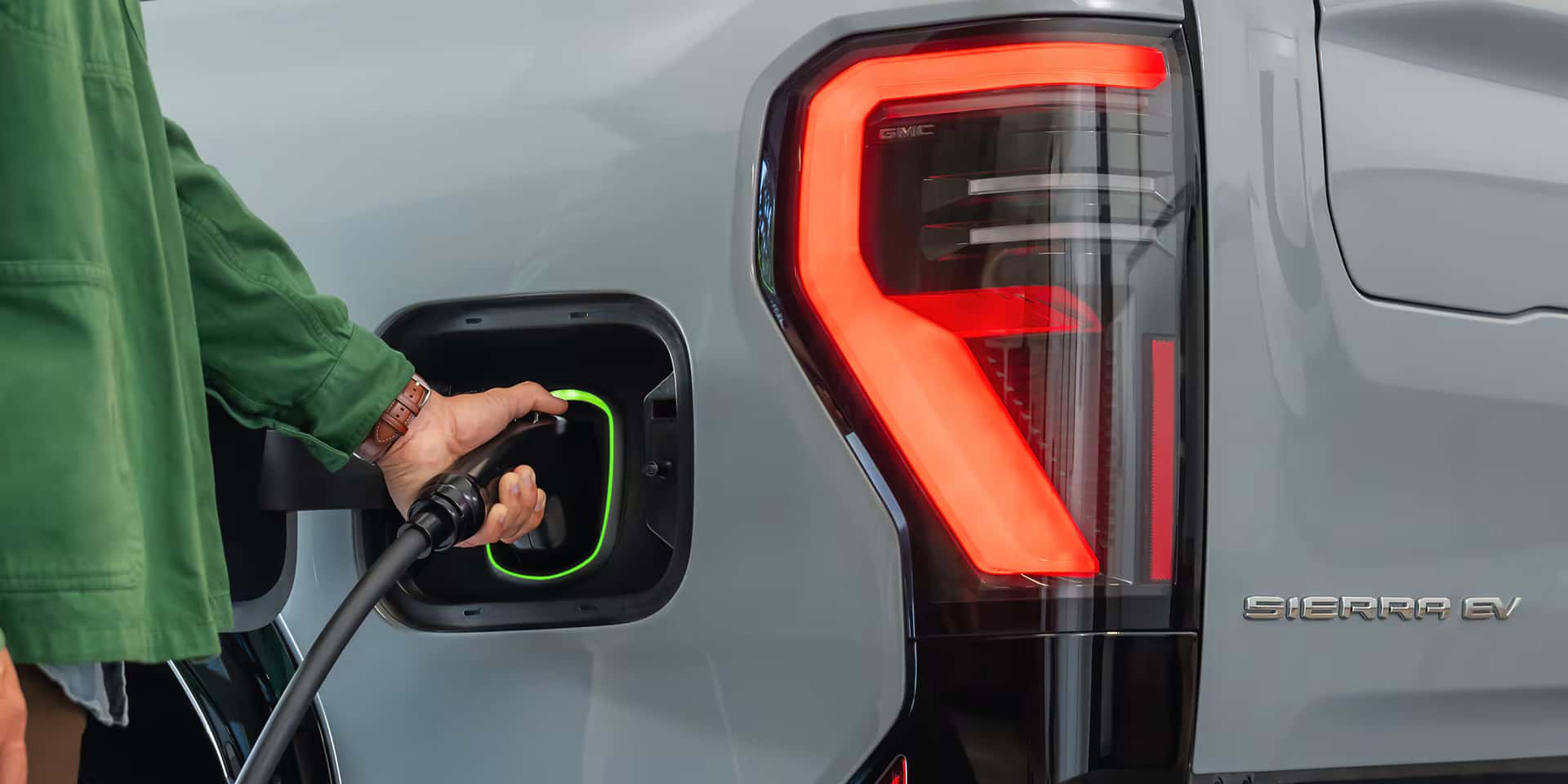 2026 GMC Sierra EV plugged into a charger