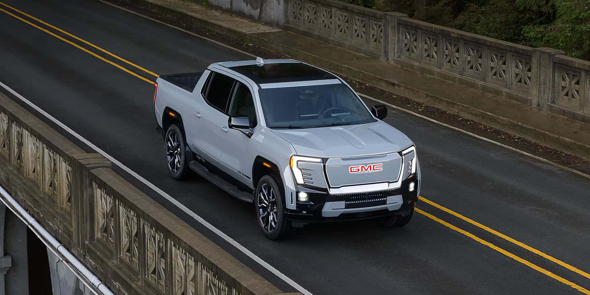 2026 GMC Sierra EV driving on a road