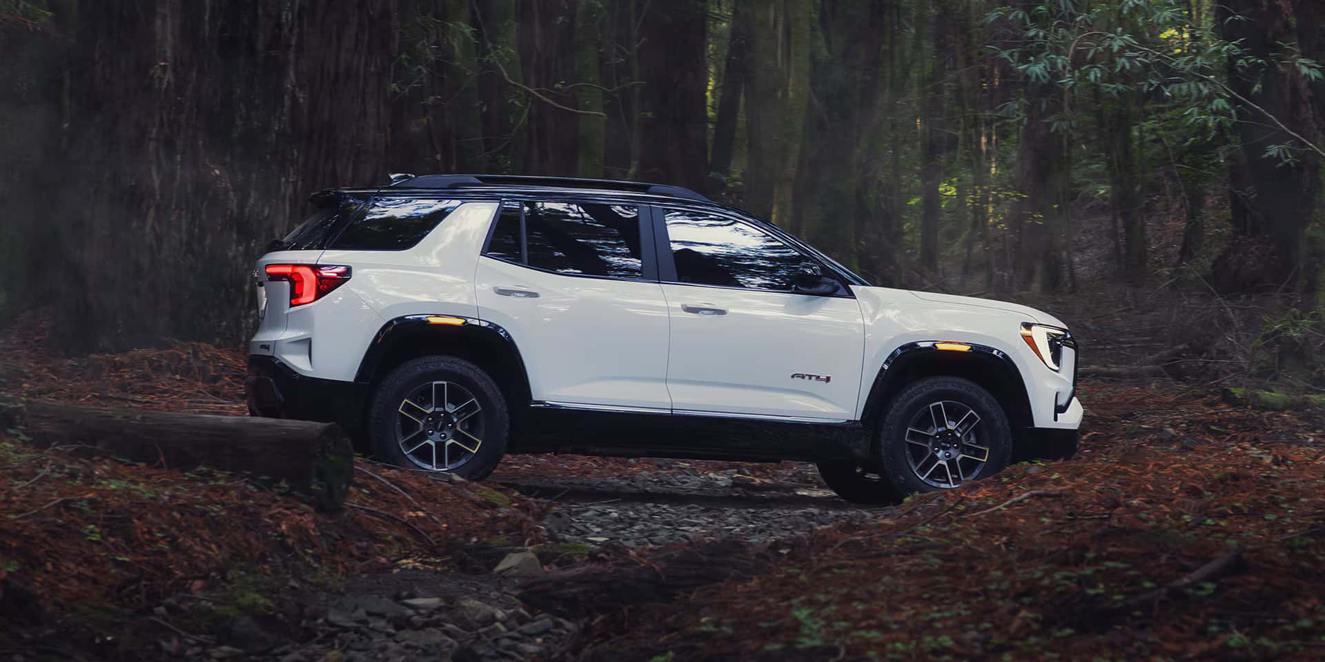 2026 GMC Terrain at4 driving in the forest