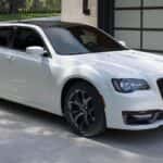 white 2021 chrysler 300 font and side view parked