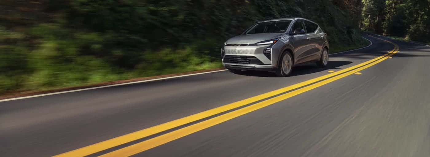 chevrolet_bolt_2027_silver_trees_exterior_road_oa7gxh-DI-Slider-Desktop-1400x512