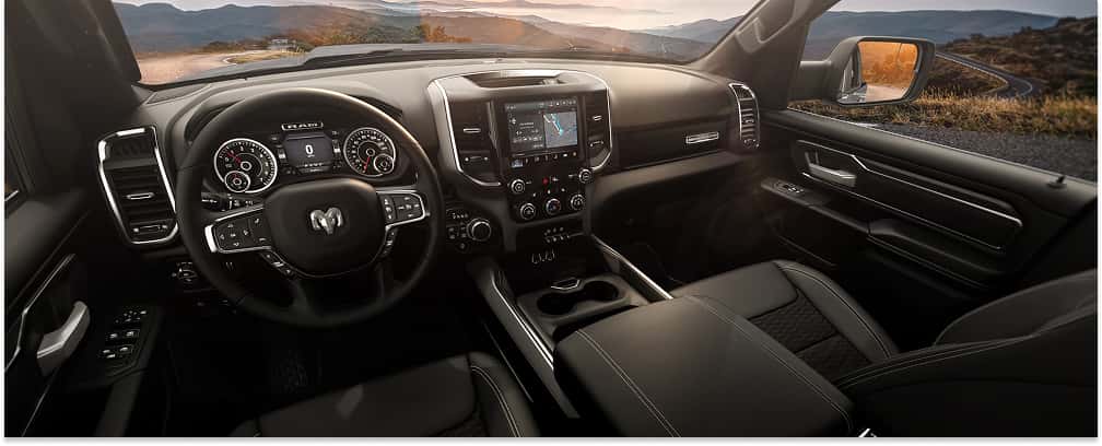 Black interior cabin and dashboard of a 2026 RAM 1500 Big Horn pickup truck.