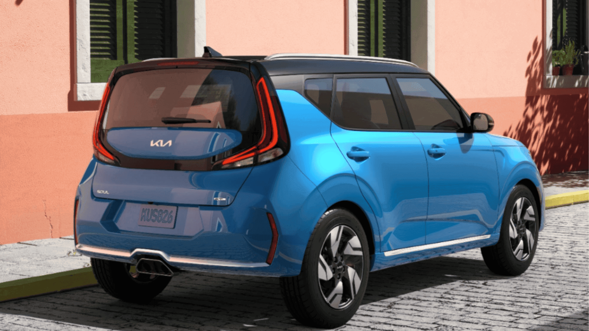Rear view of the 2024 Kia Soul parked near a coral-colored building