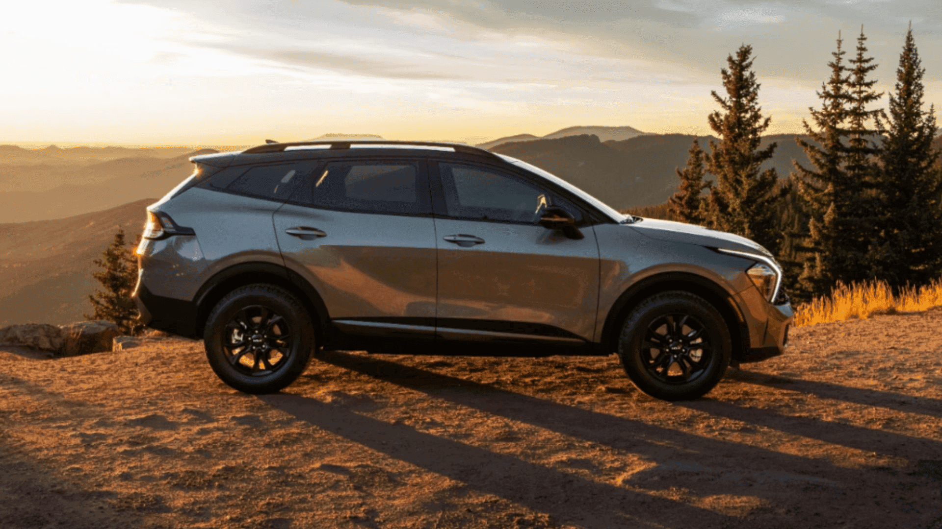 Side view of Kia Sportage parked at a mountain overlook