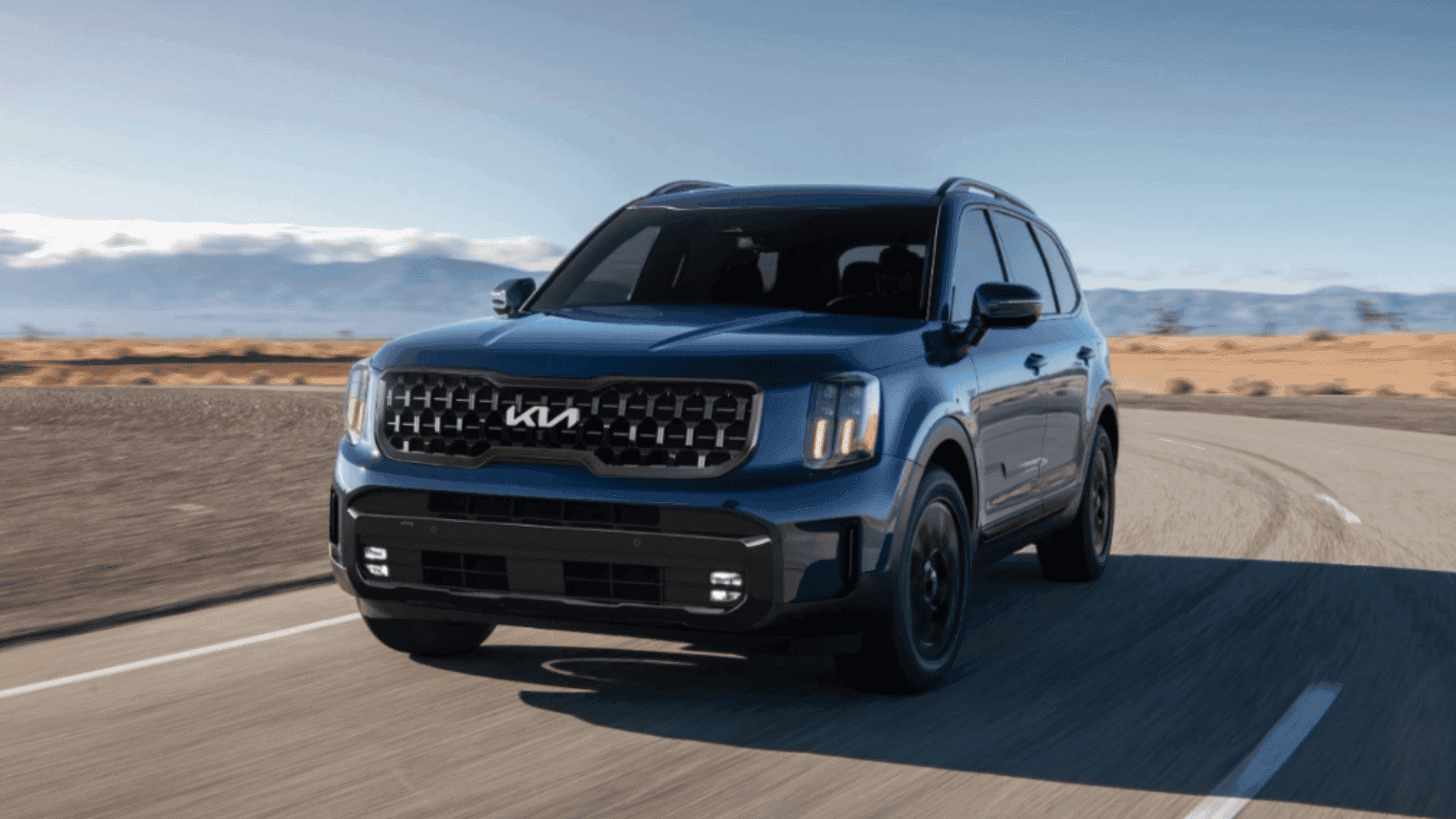 Front angle of 2024 Kia Telluride driving on curved desert highway