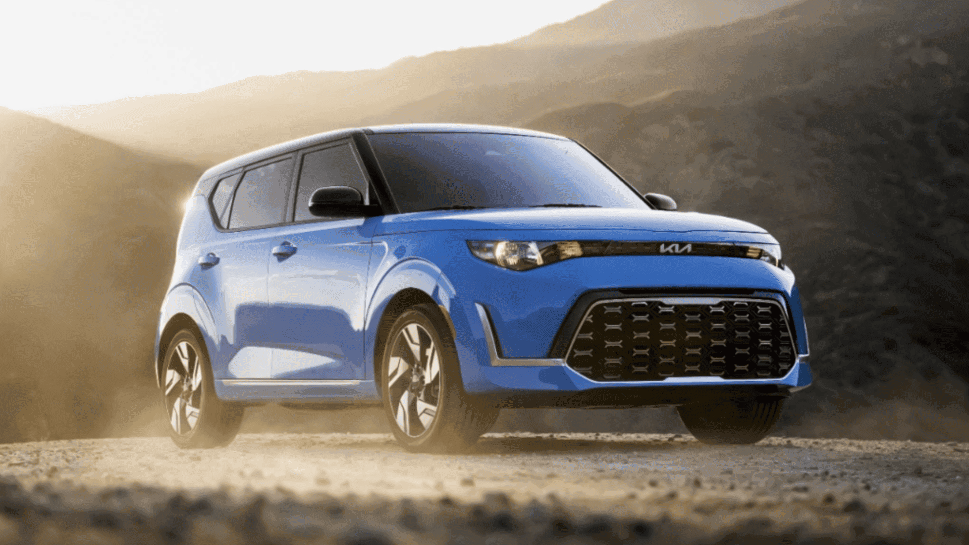 Front view of the 2024 Kia Soul driving on a dusty mountain road