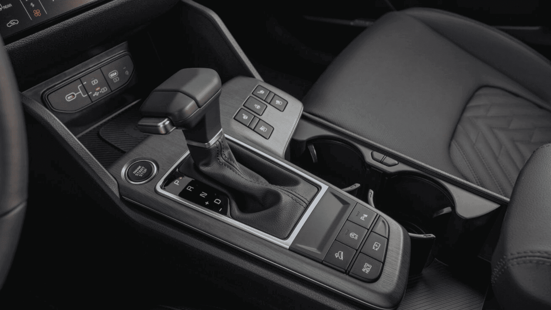 Close-up view of 2026 Kia Sportage center console with gear shifter and control buttons.