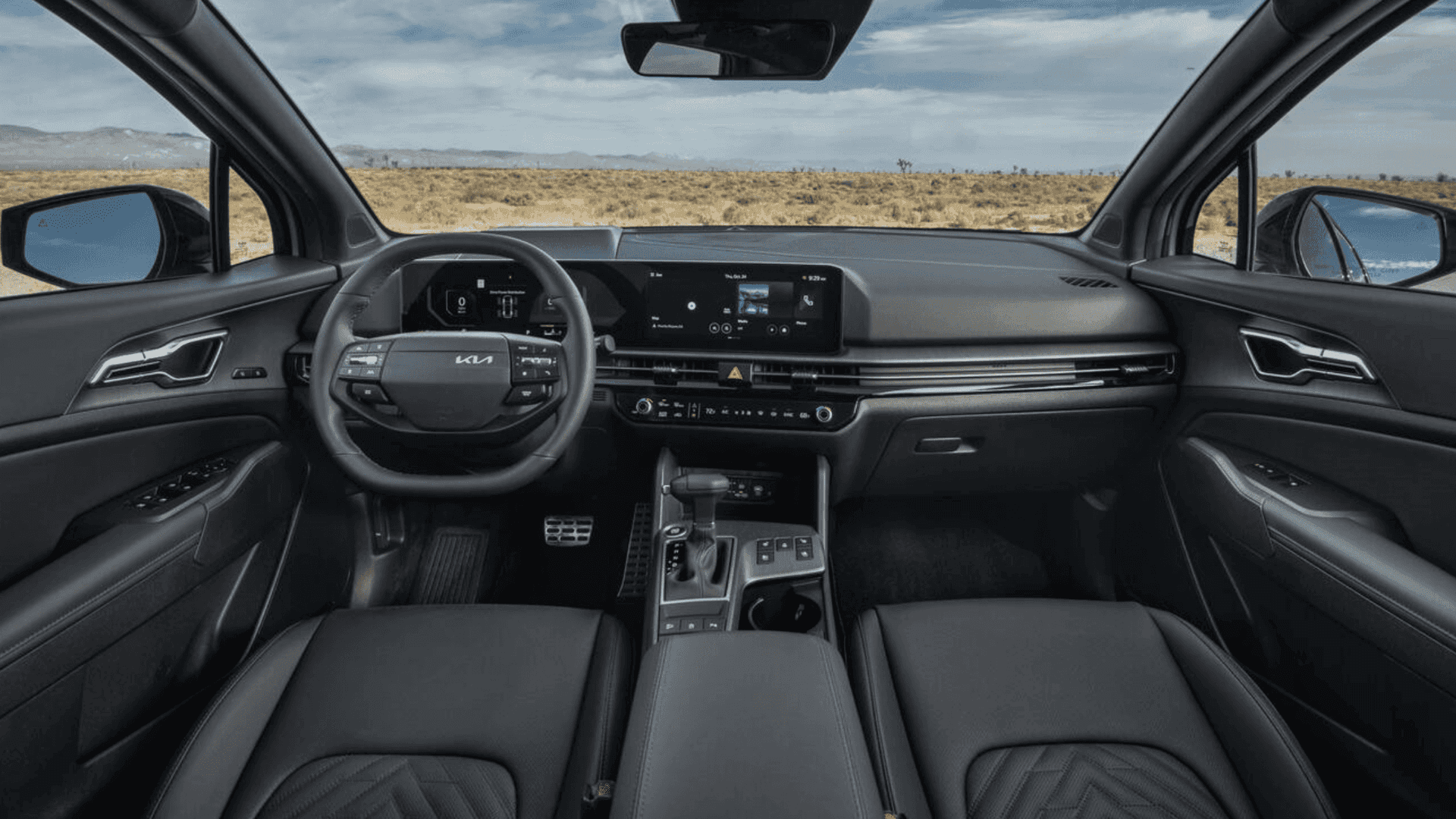 Driver’s view of 2026 Kia Sportage interior showing dashboard, steering wheel, and displays.