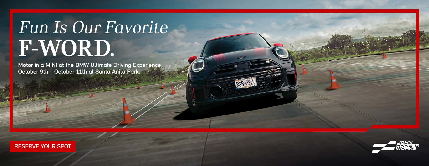Black MINI JCW racing through a track.