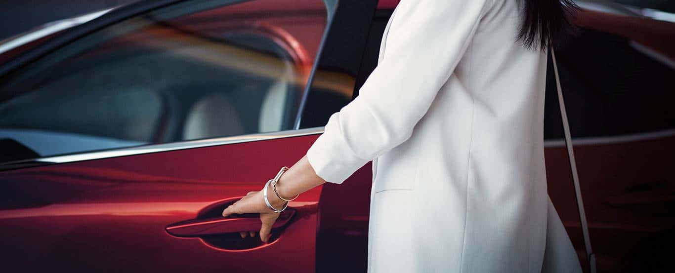 Image of a woman getting into a Mazda vehicle for a blog post for Culver City Mazda about Mazda Maintenance Tips