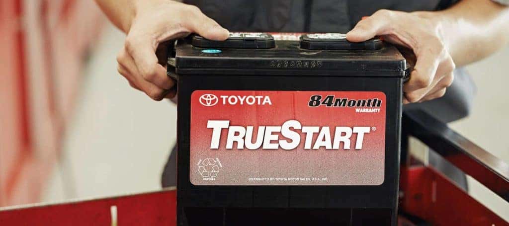 Toyota service technician holding a battery