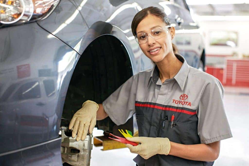 Toyota service technician working on brakes