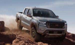 2023 Nissan Frontier driving down a hill