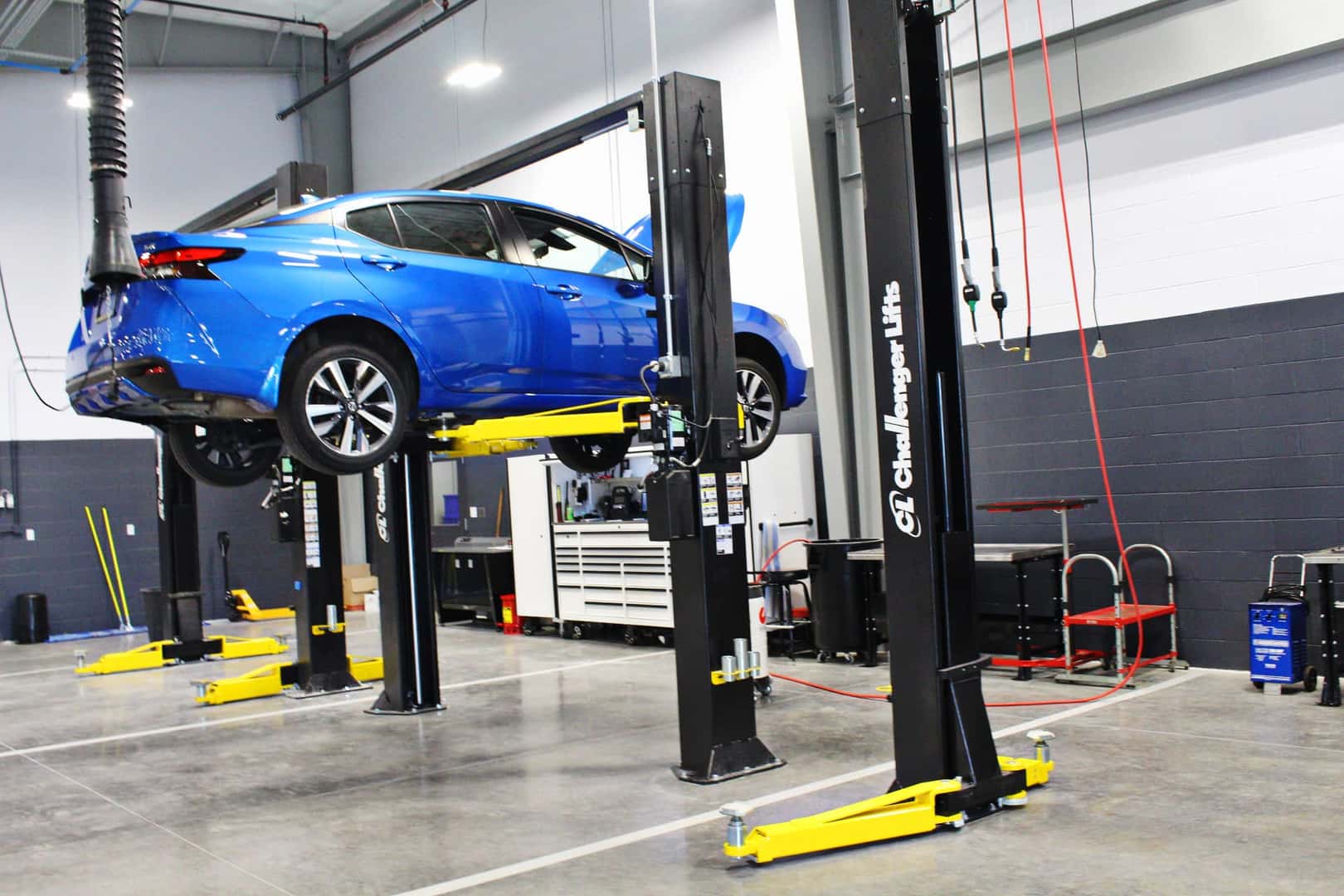 Blue Nissan getting auto maintenance