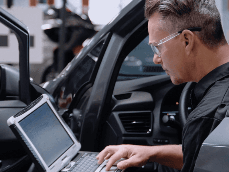 Nissan Collision Repair technician performing vehicle repairs