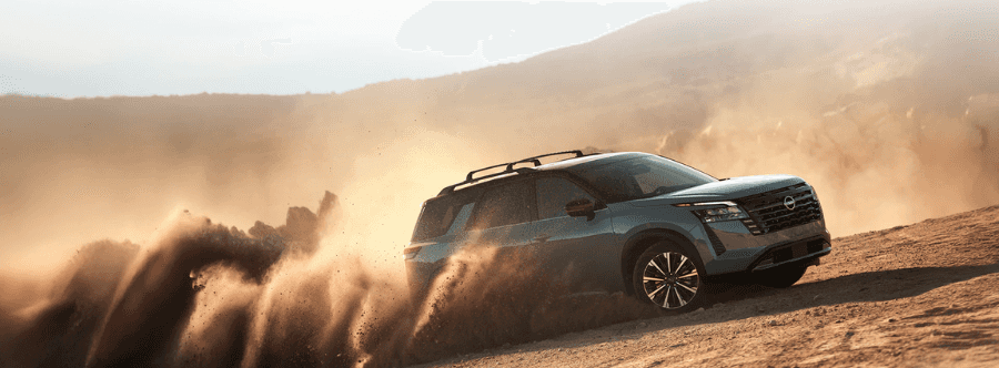 2026 Nissan Rogue vs Nissan Pathfinder Family SUV Guide 2026 Nissan Pathfinder driving through sand