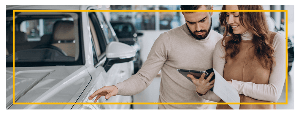 Things to Bring with you to Purchase a Car at Delaney Chevrolet of Indiana in Indiana, PA | Man and woman looking a documents needed to purchase a car at a dealership