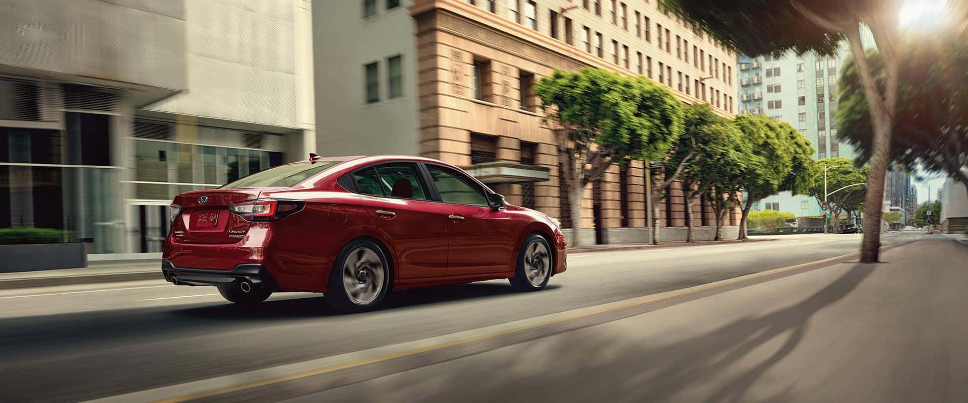 2025 Subaru Legacy at Delaney Subaru in Indiana, PA | Red Subaru Legacy Driving Through City Streets
