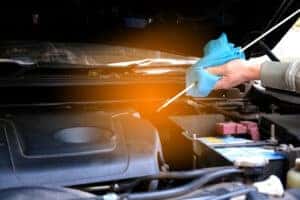 Mechanic checking engine oil 