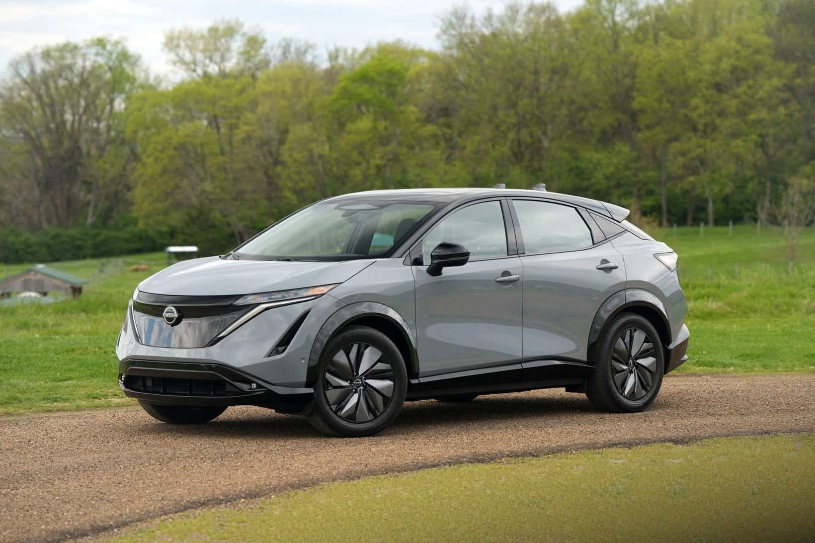 The Beautiful 2024 Nissan Ariya, Parked Near A Treeline