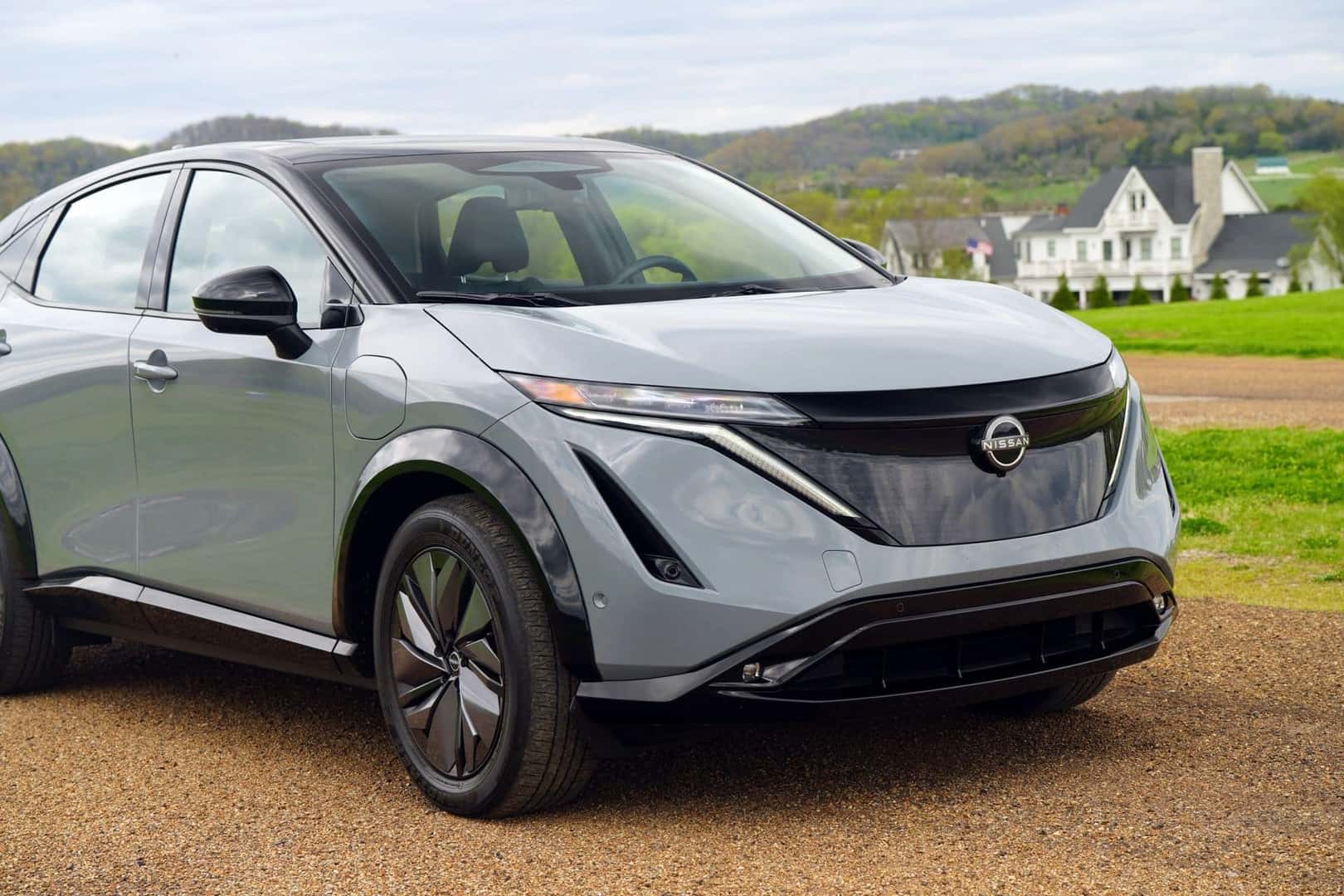 The Homy Exterior Of The 2024 Nissan Ariya, Rolling Past Country Homes
