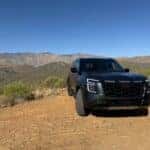 2025 Nissan Armada earned its PRO-4X front end view with mountain view in the background
