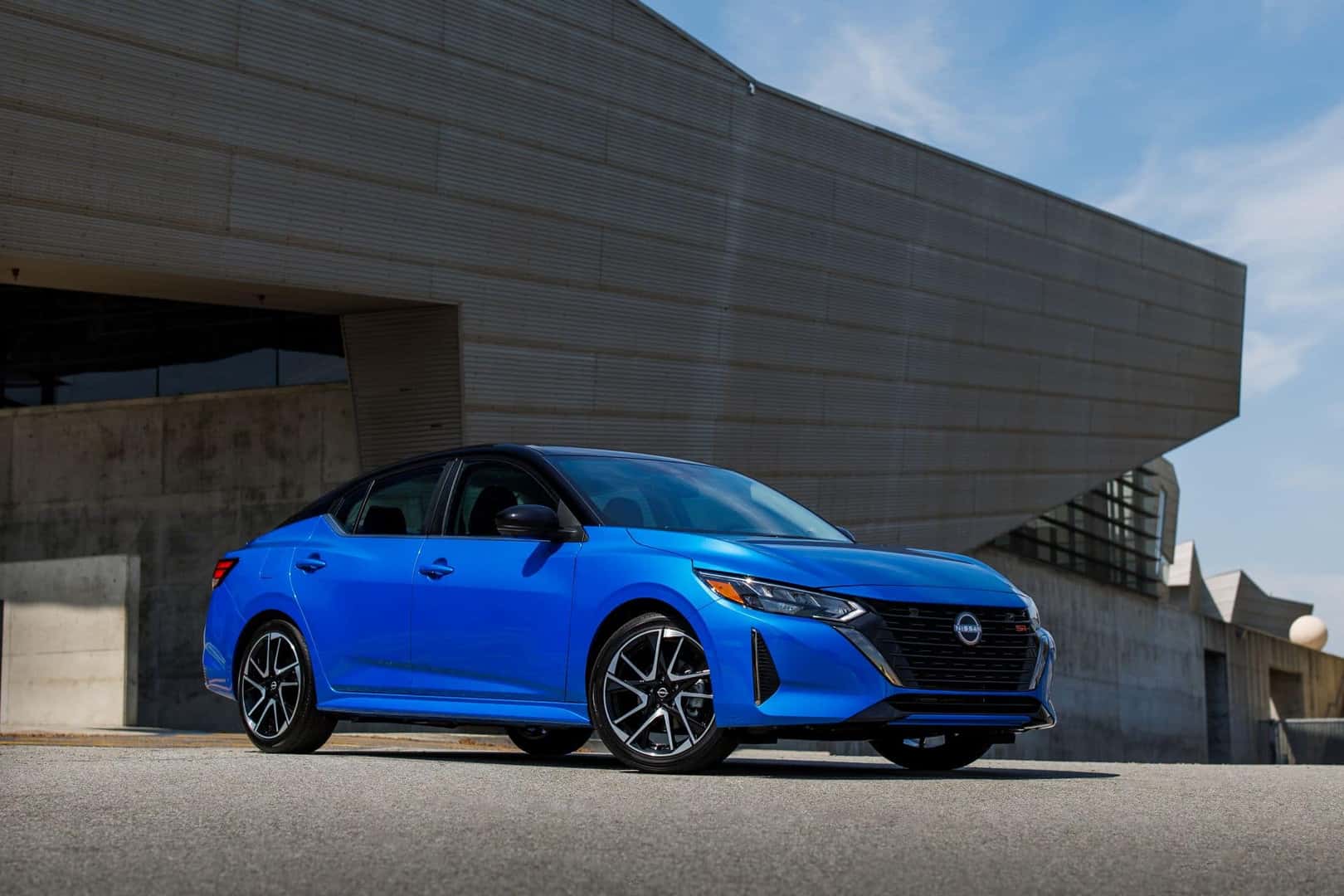 The J.D. Power IQS Winner, The 2025 Nissan Sentra, Parked Outside A Beautiful Piece Of Architecture