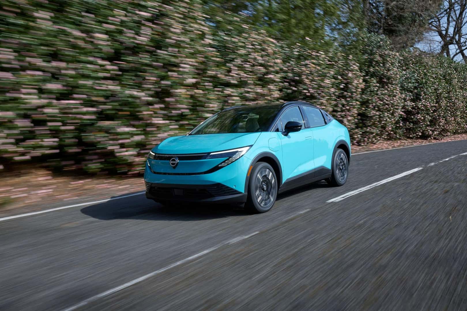 The Dashing 2026 Nissan Leaf Driving On A Newly Paved Road