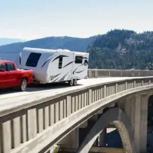 2026 Nissan Frontier Red Alert towing over a bridge