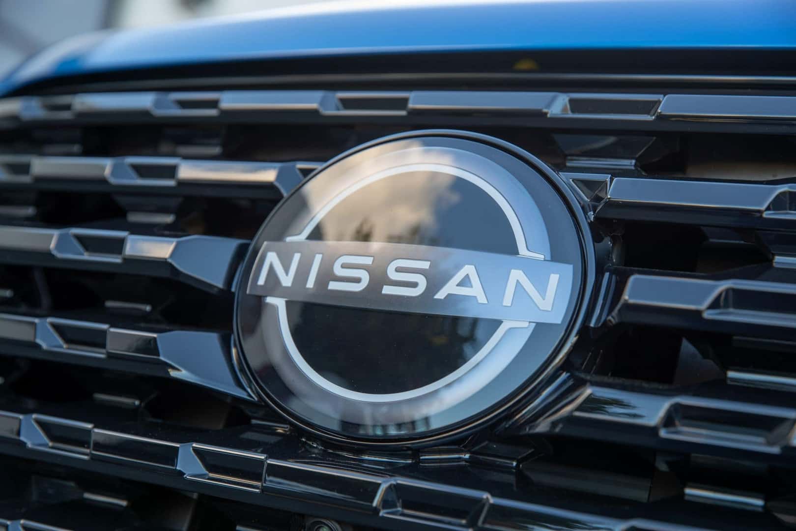 The Polished Nissan Logo On The Front Exterior