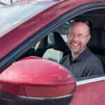 The Acclaimed Nissan Sound Engineer, Patrick Dennis, pictured Inside A Red Vehicle