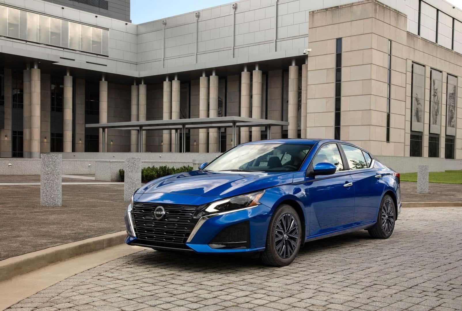 The Quality Midsize Vehicle, The 2025 Nissan Altima, Parked Outside An Important And Influential Building