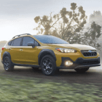 Subaru Crosstrek driving down a foggy road