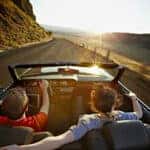 Couple driving in a convertible