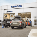 Subaru driving into a service center