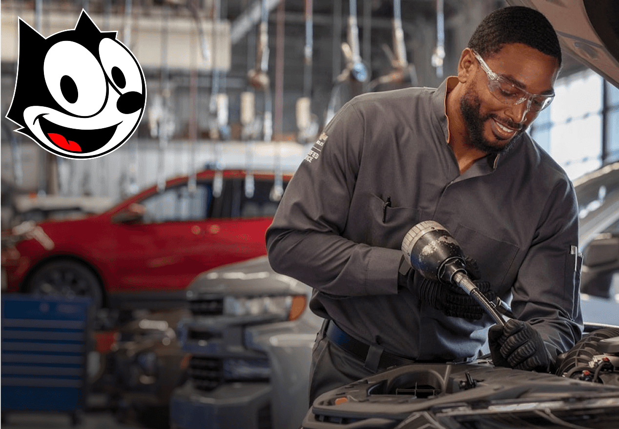 A man working on an engine in an auto shop