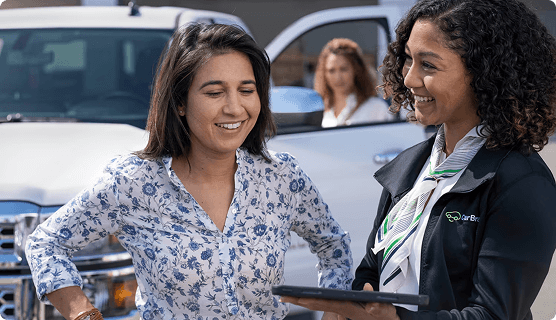 Salesperson showing tablet to customer
