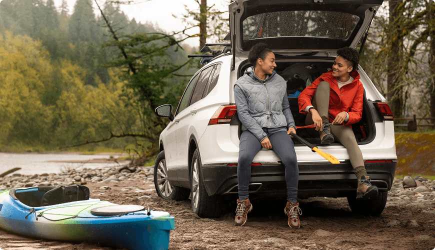 Couple sitting on the back of a car