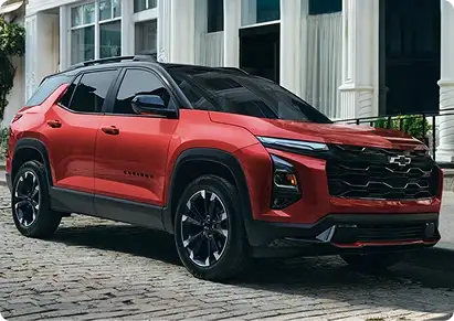 Red Chevrolet Equinox rear three-quarter view on a cobblestone street