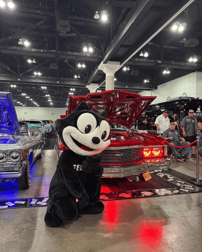 Felix the Cat with a custom lowrider at a Los Angeles car show