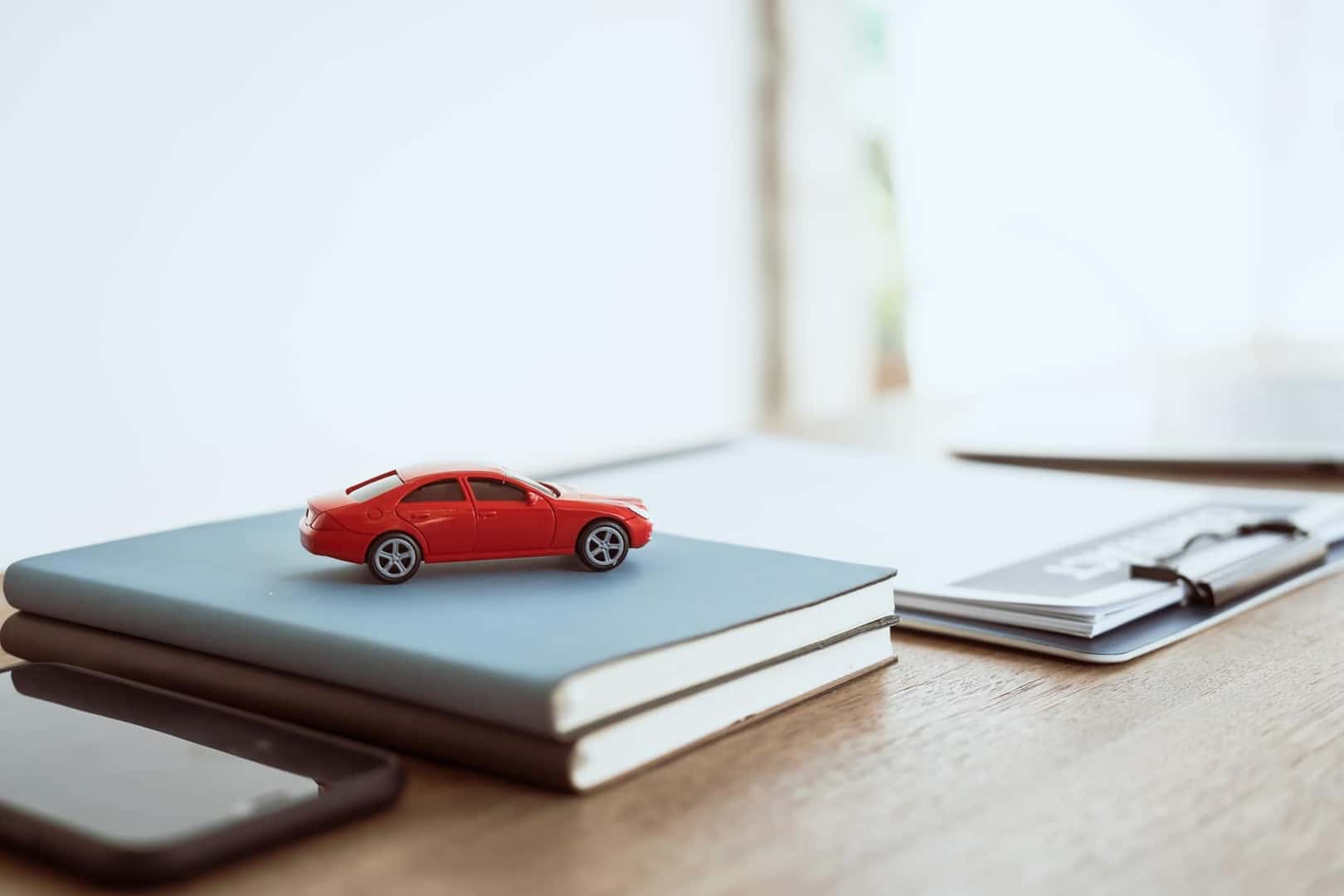 Toy car on top of papers and notebooks in an office