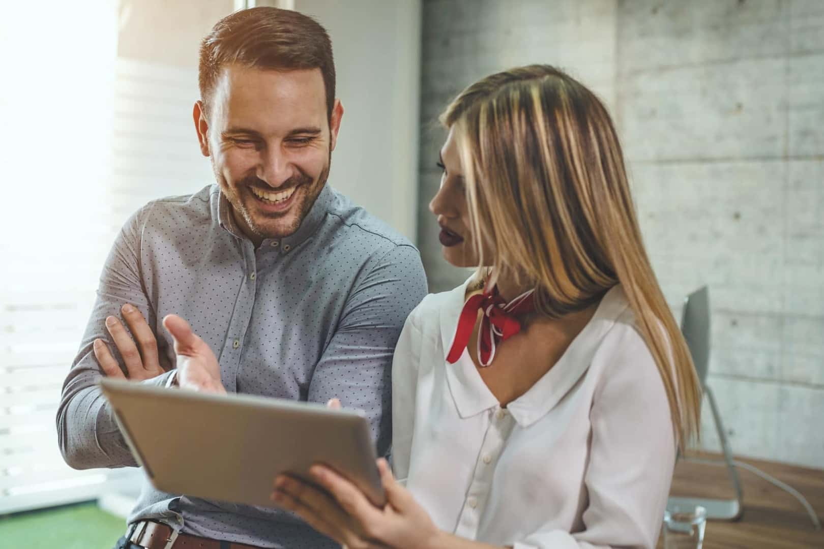 Couple looking at electric vehicle options on tablet